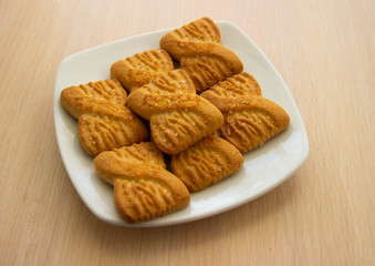 The photo of a pile of  cookies or shortcake biscuits on the plate. National Cookie Day background