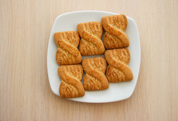 The photo of a pile of  cookies or shortcake biscuits on the plate. National Cookie Day background