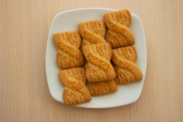 The photo of a pile of  cookies or shortcake biscuits on the plate. National Cookie Day background