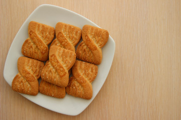 The photo of a pile of  cookies or shortcake biscuits on the plate. National Cookie Day background