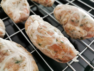  Traditional Cypriot food. Sheftalia : Cypriot Lamb and Pork Sausages. Raw sausages on a metal grill before baking.