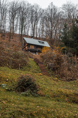 Cottage in the hill. Autumn landscape with yellow-orange and fallen leaves. Nature Trail Svatojanske proudy. Slapy, Czech Republic. 