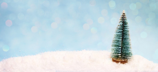 A small toy tree in the snow, a banner for the site header