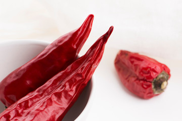 Bowl of red hot chili pepper on white background