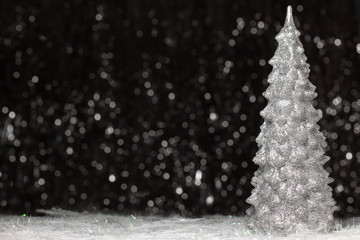 Christmas silver tree decoration of the right site on dark background with silver color bokeh. Holiday concept with copy space