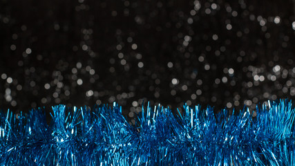 Christmas blue decorations on dark background with silver colors bokeh. Holiday concept with copy space