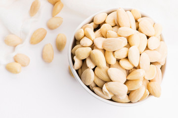 Bowl of almonds on a white background