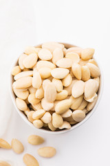 Bowl of almonds on a white background