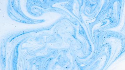 Fototapeta premium Fluid Art with white blue color. Abstract multicolored background. Blue white texture. Colored paint stains in liquid. Marble art. Fantastic iridescent colors
