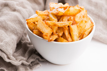 Bowl of potatoe fries on a white background
