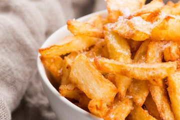 Bowl of potatoe fries on a white background