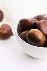 Bowl of chestnuts on a white background