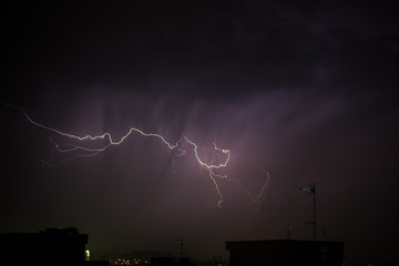 Thunderbolt over the city during a storm at night