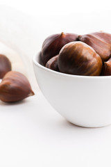 Bowl of chestnuts on a white background