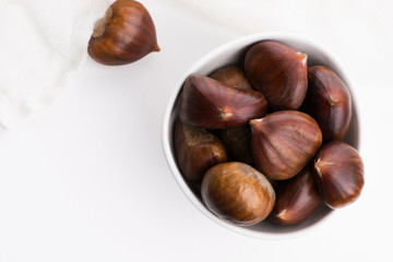 Bowl of chestnuts on a white background