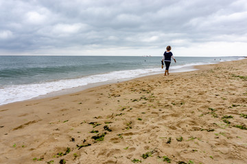 woman on the green beach. walking on the beach, Algarve, Portugal.