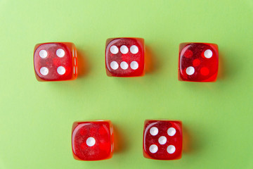Red dice lying on a green background. Place for text