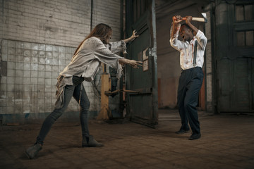 Female zombie fights with scaried man