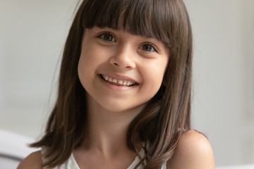 Closeup portrait of beautiful brown haired seven years old girl