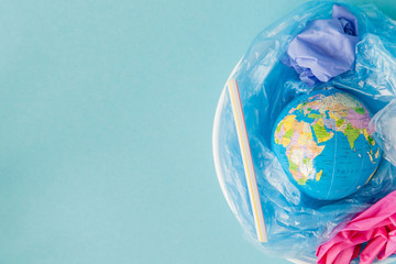 The concept of reducing plastic bags use: Modeled globes are sunk in many white plastic bags. Meaning, plastic bags are about to overflow the world - obrazy, fototapety, plakaty