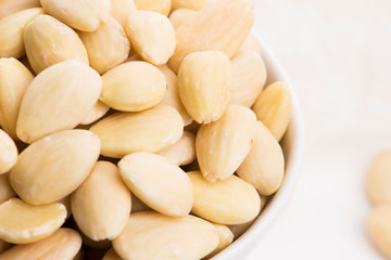 Bowl of almonds on a white background