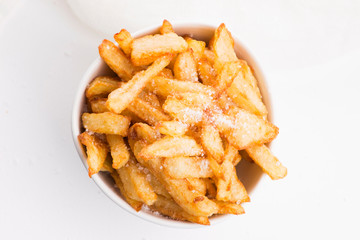 Bowl of potatoe fries on a white background