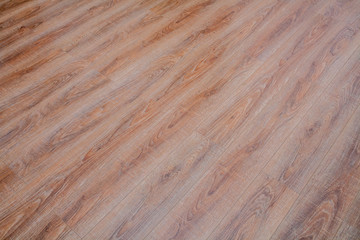 The floor of the light brown laminate diagonally