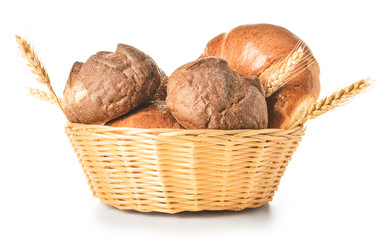 Basket with fresh bakery products on white background