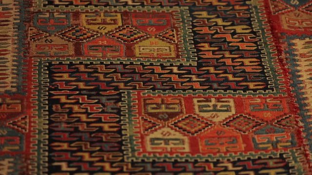 Large oriental rug with colorful patterns. Handmade rug production, carpet close-up with all the details