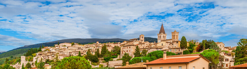 Fototapeta na wymiar Panoramic view of Spello medieval hisitoric center in Umbria countryside with clouds above