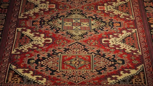 Large oriental rug with colorful patterns. Handmade rug production, carpet close-up with all the details