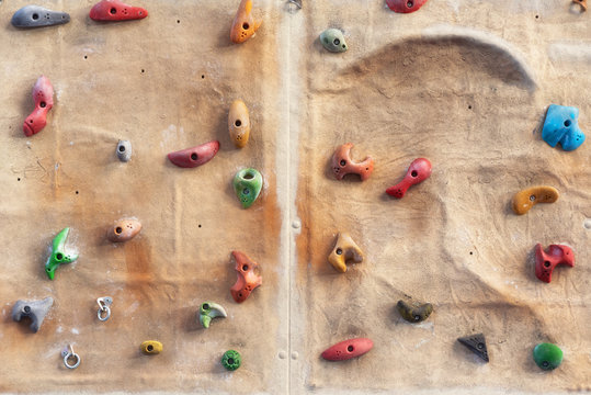 Artificial indoors rock climbing wall background . 