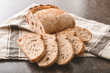 Sliced fresh bread on dark table