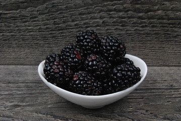 Dish of fresh Blackberries on rustic wood
