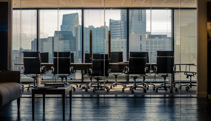 Empty conference room workspace showing cityscape skyline.