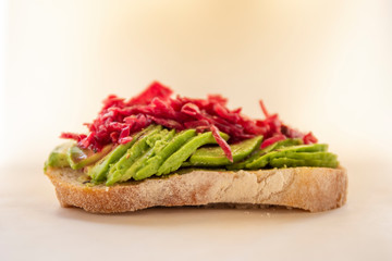 Sauerkraut on the top of avocado and sourdough bread