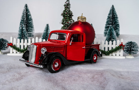 Old Red Pickup Truck With Giant Christmas Ornament