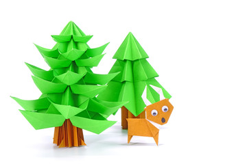 Origami paper art : Santa Claus's reindeer and Christmas tree for greeting season of Christmas and New year. Copy space