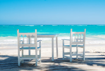Table and chairs on the beach