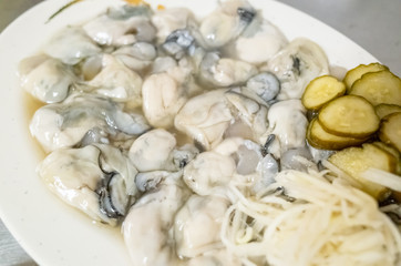 fresh oysters close-up on white plate