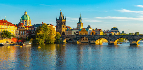 Fototapeta na wymiar View of Prague, Charles bridge and the Vltava river with tourist boats floating