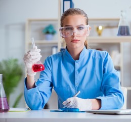 Female scientist researcher conducting an experiment in a labora