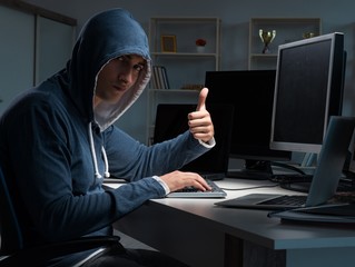 Hacker hacking computer at night