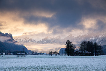 sunset and snow covered peaks in the background  Switzerland