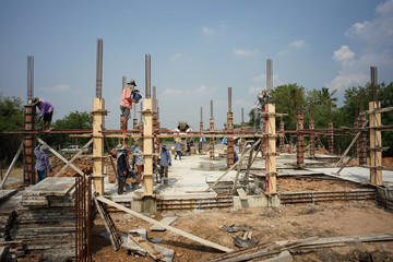 Ratchaburi, Thailand:March 1, 2018 - Group of worker build the foundation of house by pouring the mixed cement into the wooden model at the construction site