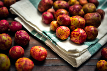 Fresh Organic Olluco Tubers (Melloco, Papalisa, Ullucus Potatoes or Ullucus tuberosus). Close up of a colorful heap of this popular root crops form the Andean region used in South America gastronomy.