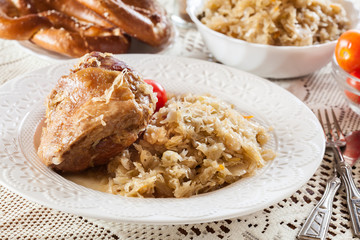 Pork knuckle with fried sauerkraut and tomatoes