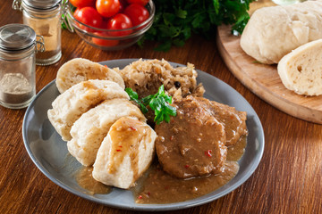 Pork loin in gravy with bread dumplings and sauerkraut