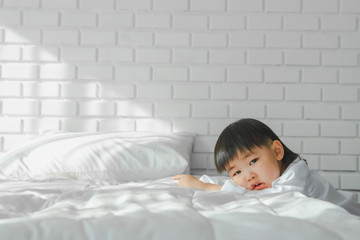 Asian Boy Japanese Children wearing white shirt on white bedroom in white room Prepare to