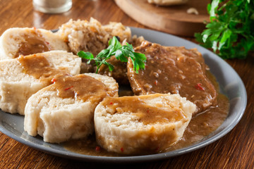 Pork loin in gravy with bread dumplings and sauerkraut